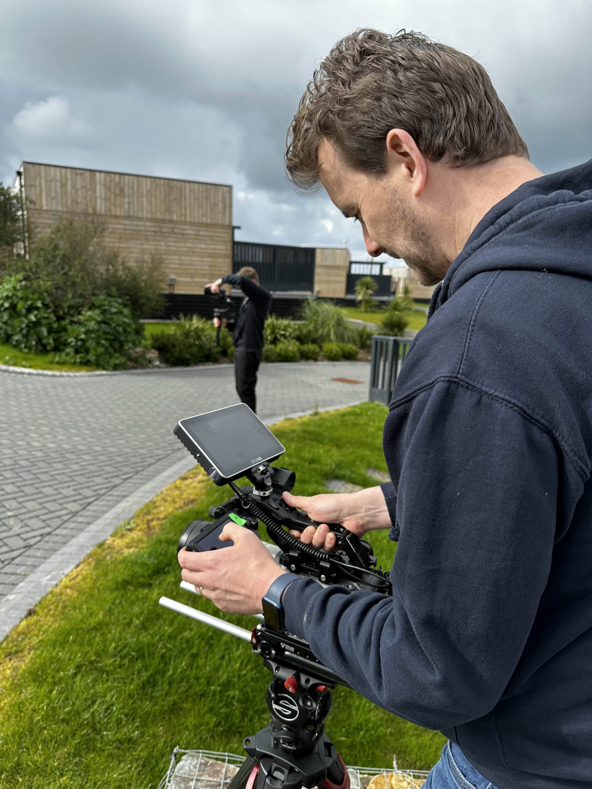 Videographer using a Sony Video Camera filming on a Satchler Tripod