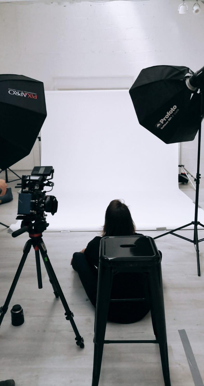 Nomadic UK - Empty white studio with two lights and a photographer and a cinema camera