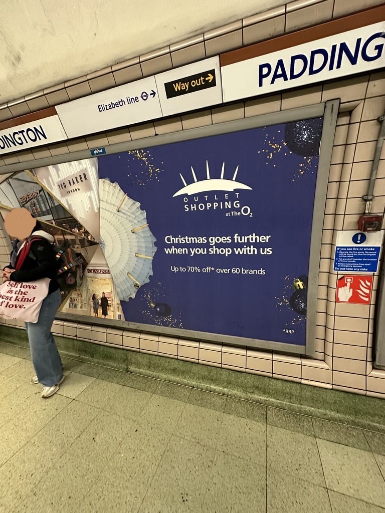 OOH of two models on a billboard at the London Underground